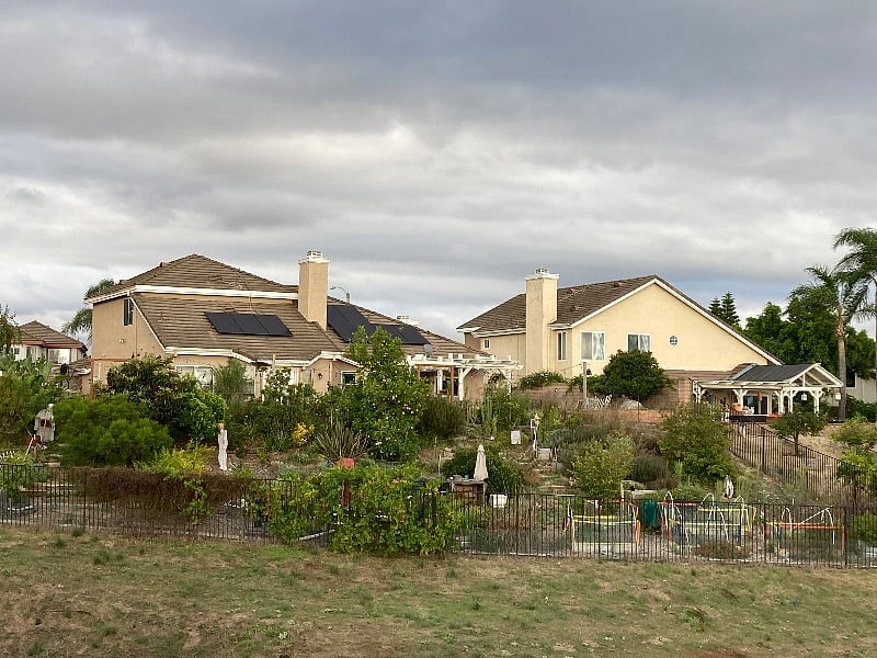 View of the back yard from walking path through public green space
