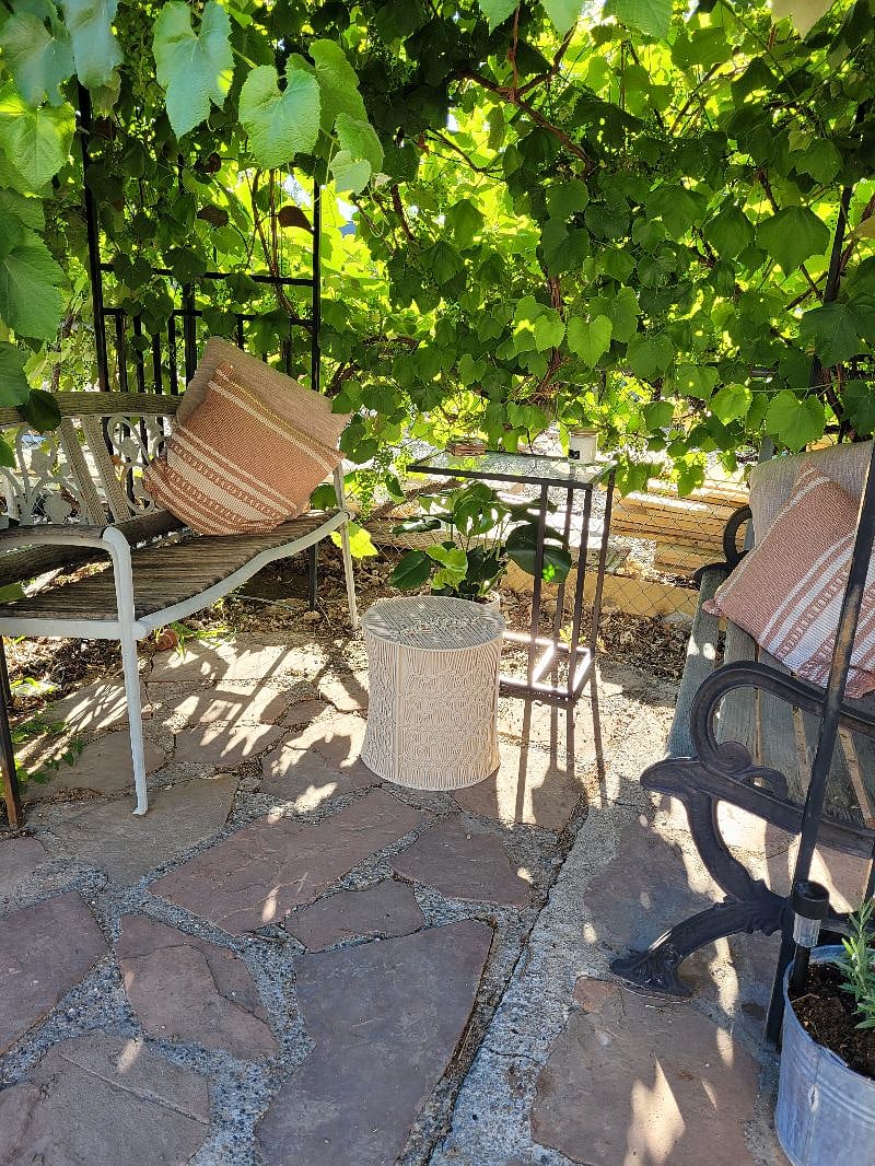 Under the grape pergola. A lovely little spot to enjoy a good book or a relaxing cocktail.