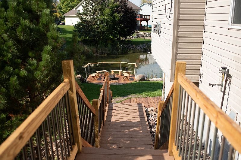 Walkway from garage down to private entrance overlooking the pond.