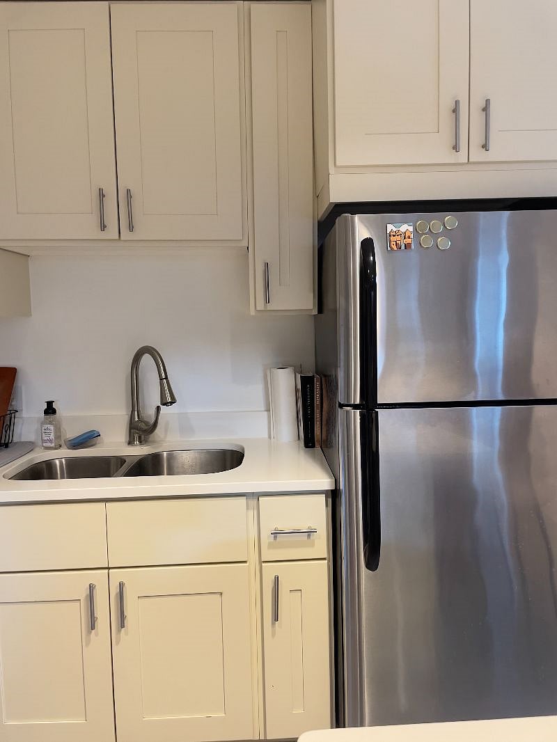 two-bowl kitchen sink plus a refrigerator and freezer