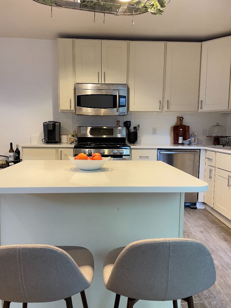 spacious kitchen with a coffee machine and counter space for cooking