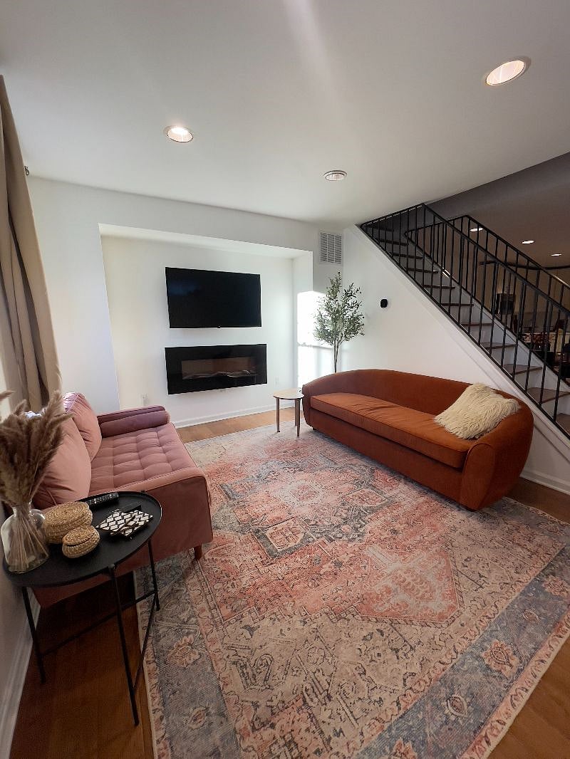 view of the living room from the entrance with the stairs to the second floor