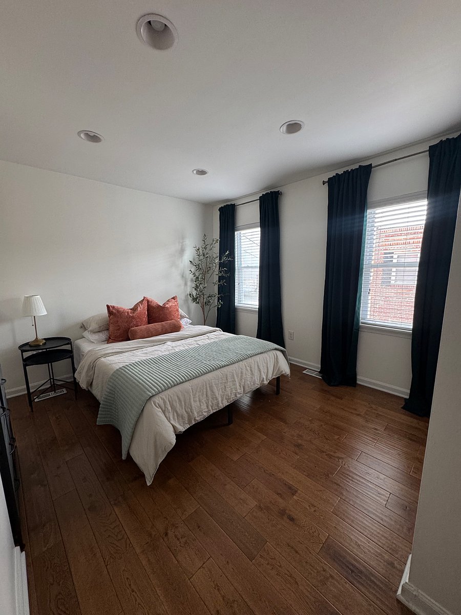 Comfy queen-size bed with blackout curtains.