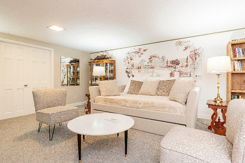 Large lower level suite w/ new queen daybed, luxurious new linens, pillows and fur duvet. Desk w/ chair, bookcase and pinter. Chest of drawers, large hanging rack. Seating area w/ chairs, coffee table & 55 TV. New carpet, new paint. Beautiul.