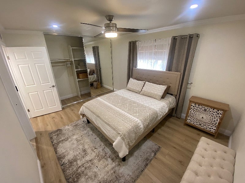 Floor-to-ceiling mirrors create a bright, open feel.