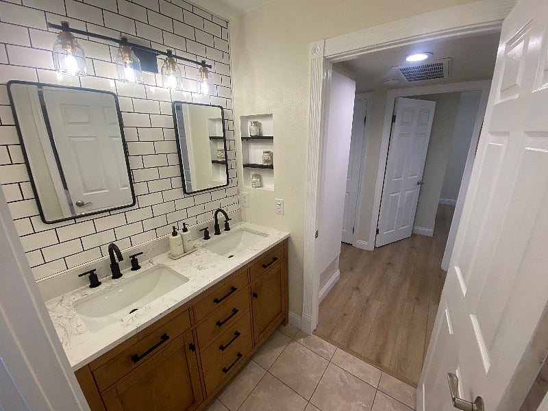 Remodeled bathroom with dual vanity and clean, modern design.