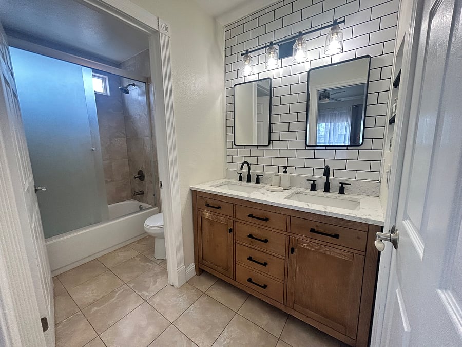 Bathroom | Remodeled bathroom with dual vanity and clean, modern design.