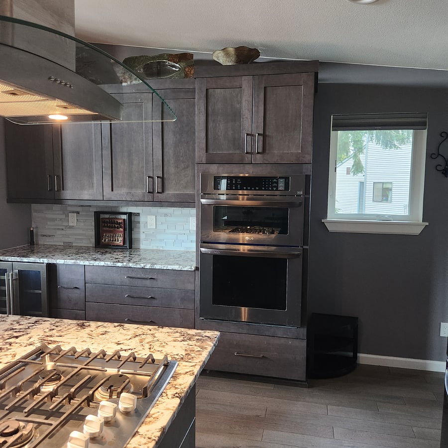 Microwave above with Oven next to Wine Nook