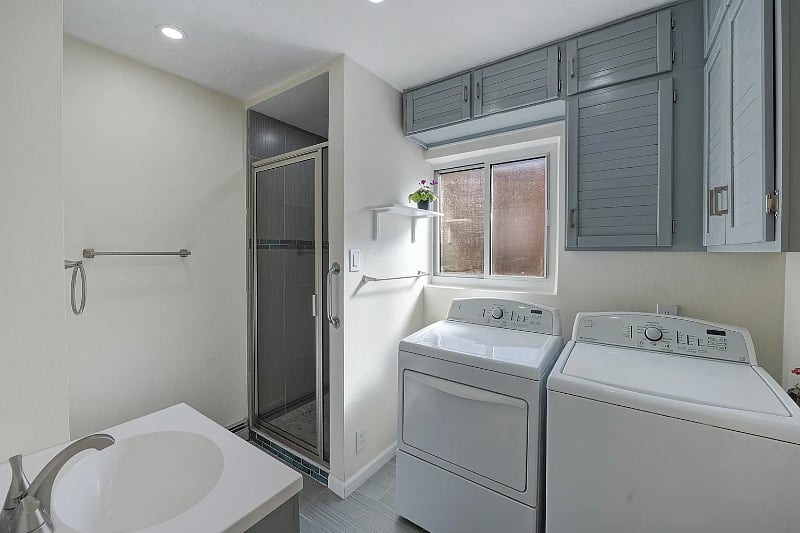 Bathroom with shower and laundry room