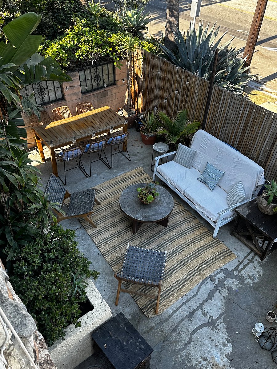 OUTDOOR PATIO WITH DINING ROOM TABLE AND BISTRO LIGHTS