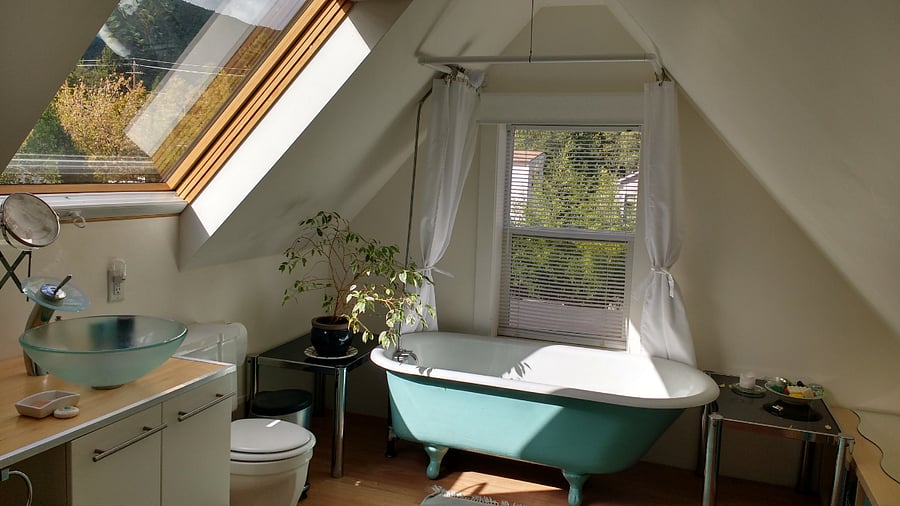 Upper bathroom with original clawfoot tub and large skylight. A washer/dryer is also here.