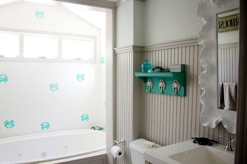 Main level bathroom has soaker tub with rain head shower - and how cute are those crab tiles? :)