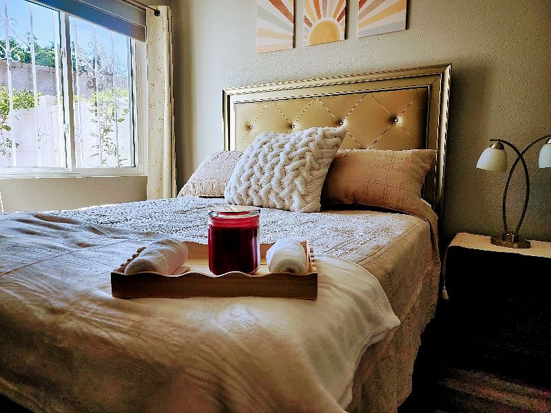 Second bedroom. Queen bed. Blackout curtains, smart TV, chest of drawers, and a mini-refrigerator. Walk in closet with cubby storage.