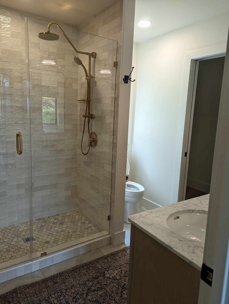 Walk in Shower in Downstairs Master Bath connected to a walk in closet