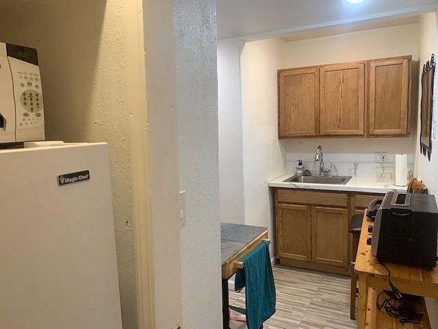 The small kitchenette lacks a full stove but has plenty of cooking options..