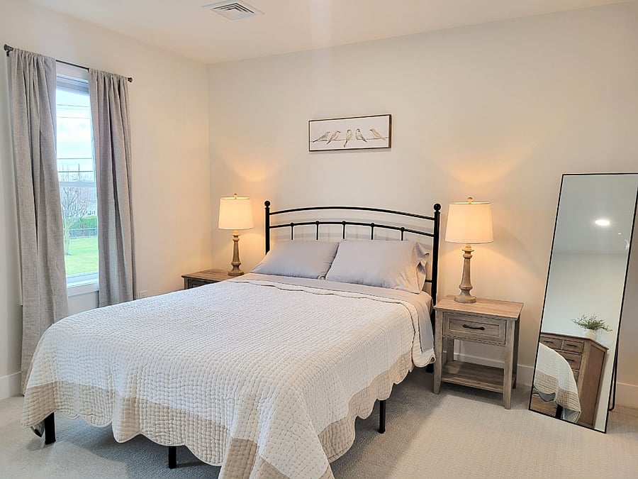 Bedroom 2 - Queen size bed with linens. Closet, dresser, shoe rack and hooks for clothes storage. Room darkening shades and curtains. Dimmable ceiling lights. Lamps.