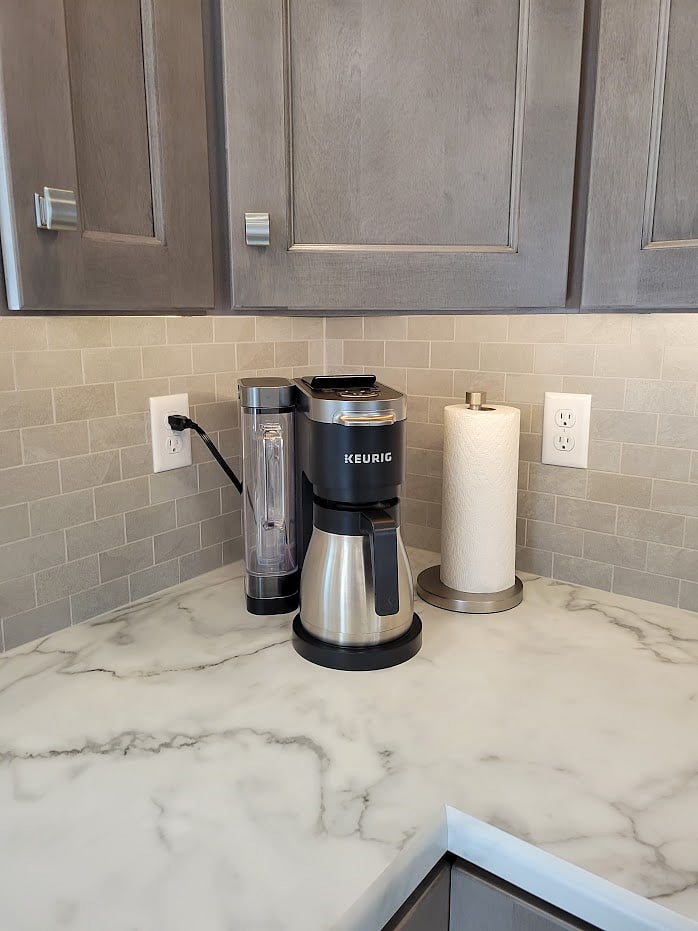 Keurig Coffee Maker brews a cup from k-cups or a pot from ground coffee. Also dispenses a cup or pot of hot water