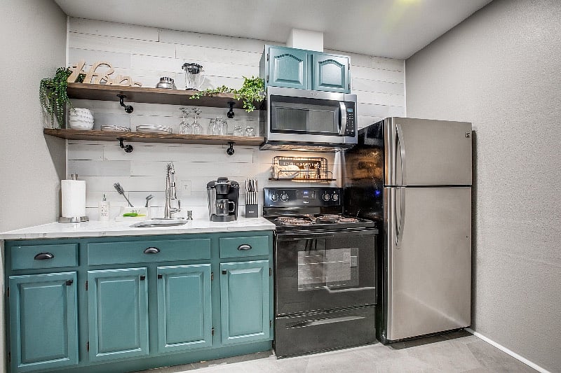 Kitchen with full size fridge and electric stove