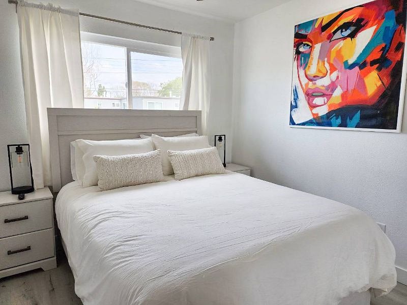 Upstairs Bedroom with Queen Bed, original artwork, room darkening shades, and 4k Smart TV!