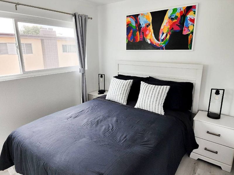 Upstairs Bedroom with Queen Bed, original artwork, room darkening shades, and 4k Smart TV!