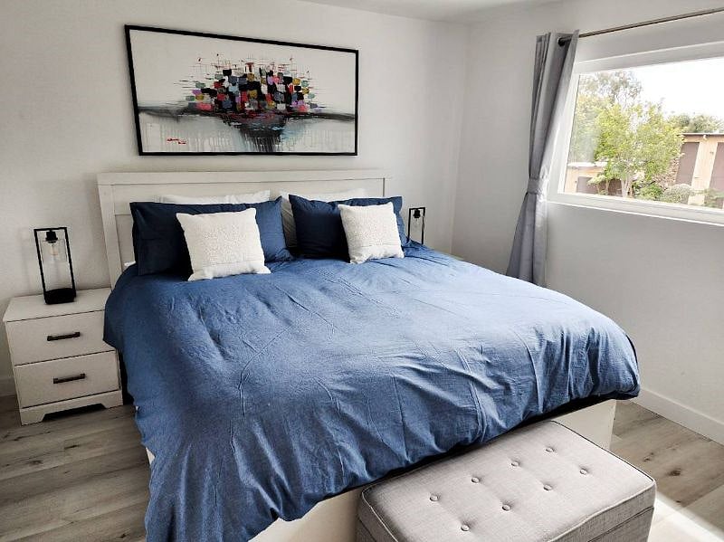 Upstairs Master Bedroom with King Bed, large closet, room darkening shades, original artwork, and large 4k Smart TV!