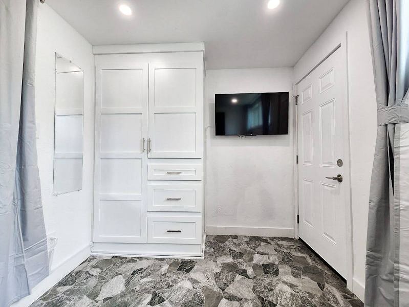 Downstairs bedroom with Large Full day bed and pull-out twin bed, original Thai artwork, room darkening shades, private exterior entrance, and 4k smart TV!