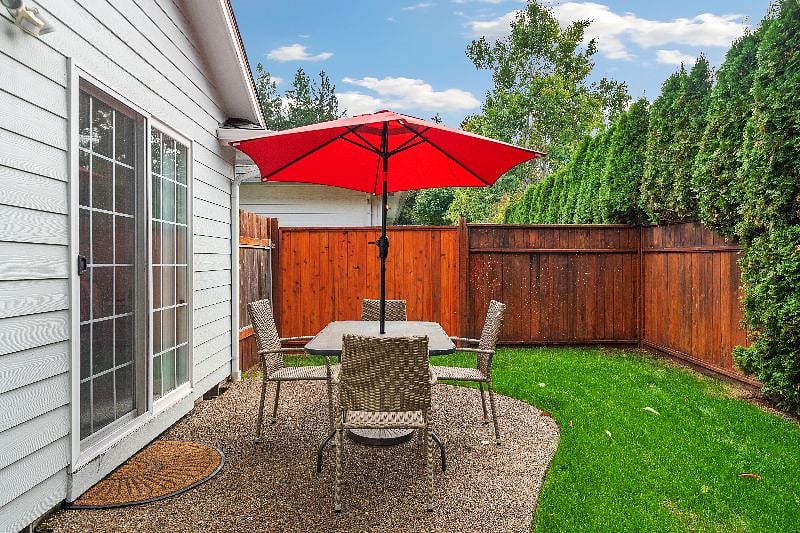 Mostly fenced yard with outside dining