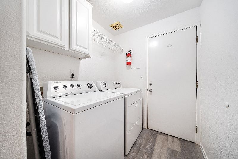 Laundry room with washer dryer and access to full sized garage