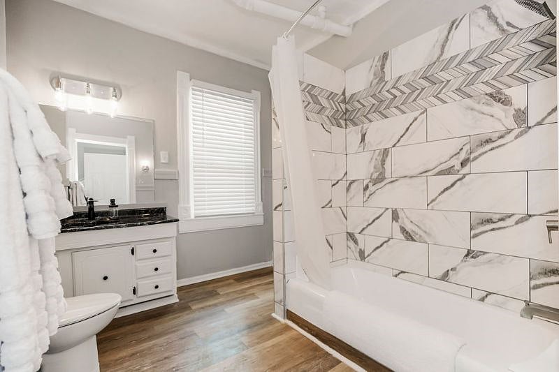 The spacious bathroom offers a full sized tub/shower and ample storage space (linen closet not pictured). Also not shows is the combo washer/dryer within the unit. 