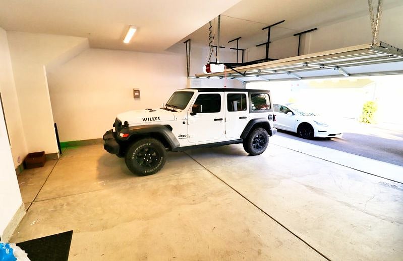 Spacious 2 car garage with extra storage space not pictured. EV charger available for install if needed. 