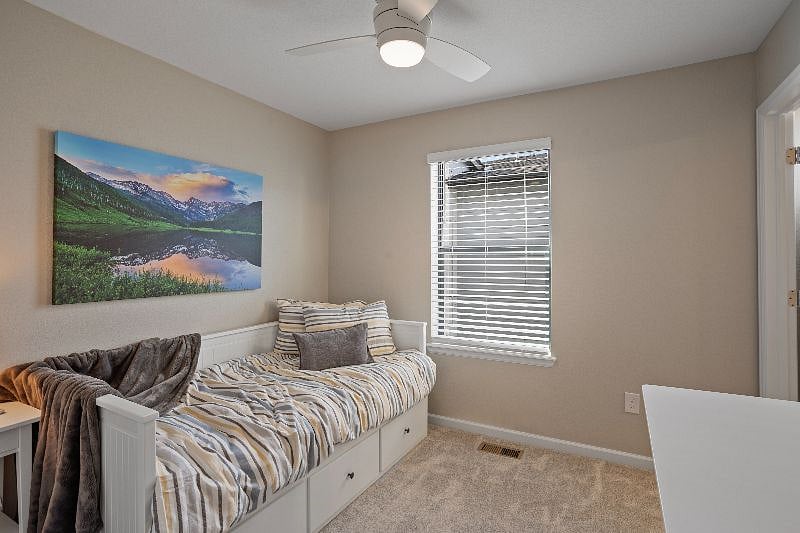 Secondary bedroom with daybed and trundle as well as a sit/stand desk