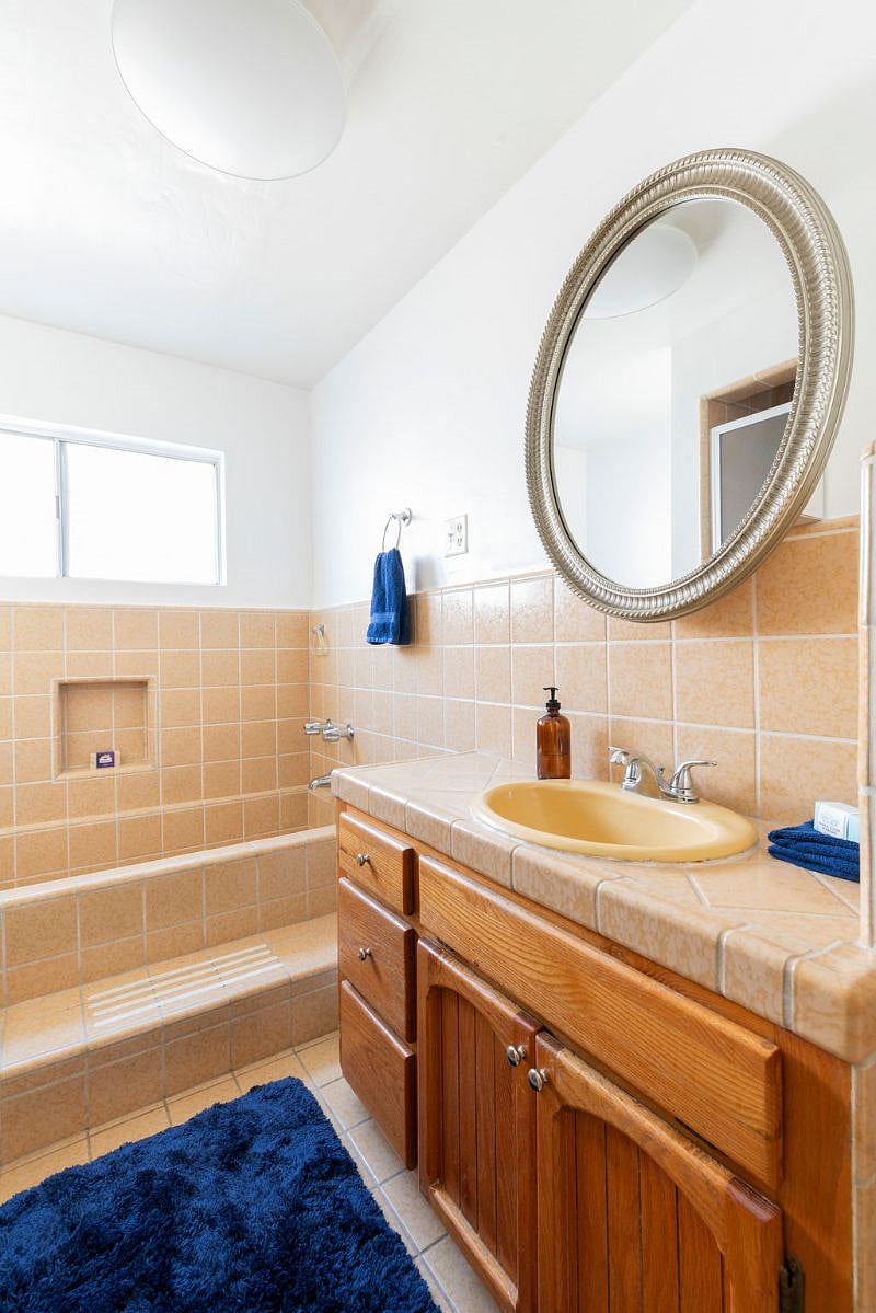 Vintage bathroom with original tiling, soaking tub, and separate stall shower