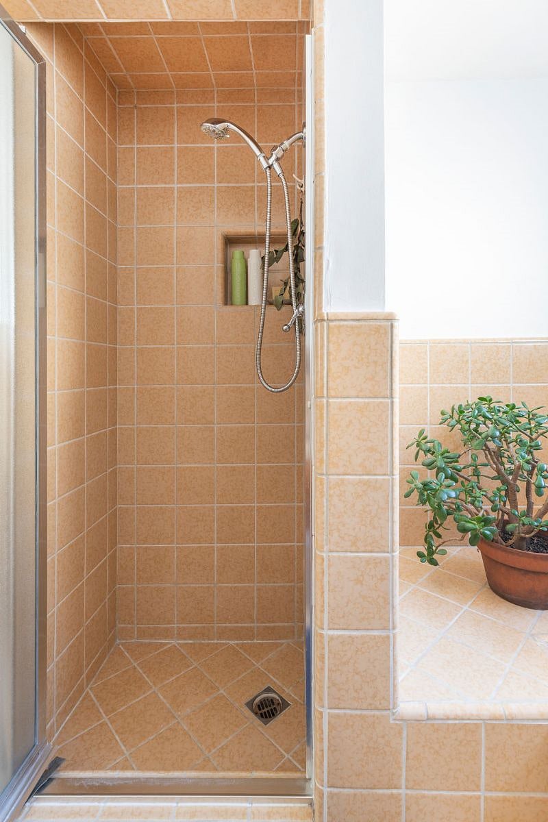 Stall shower with shampoo, conditioner, and soap