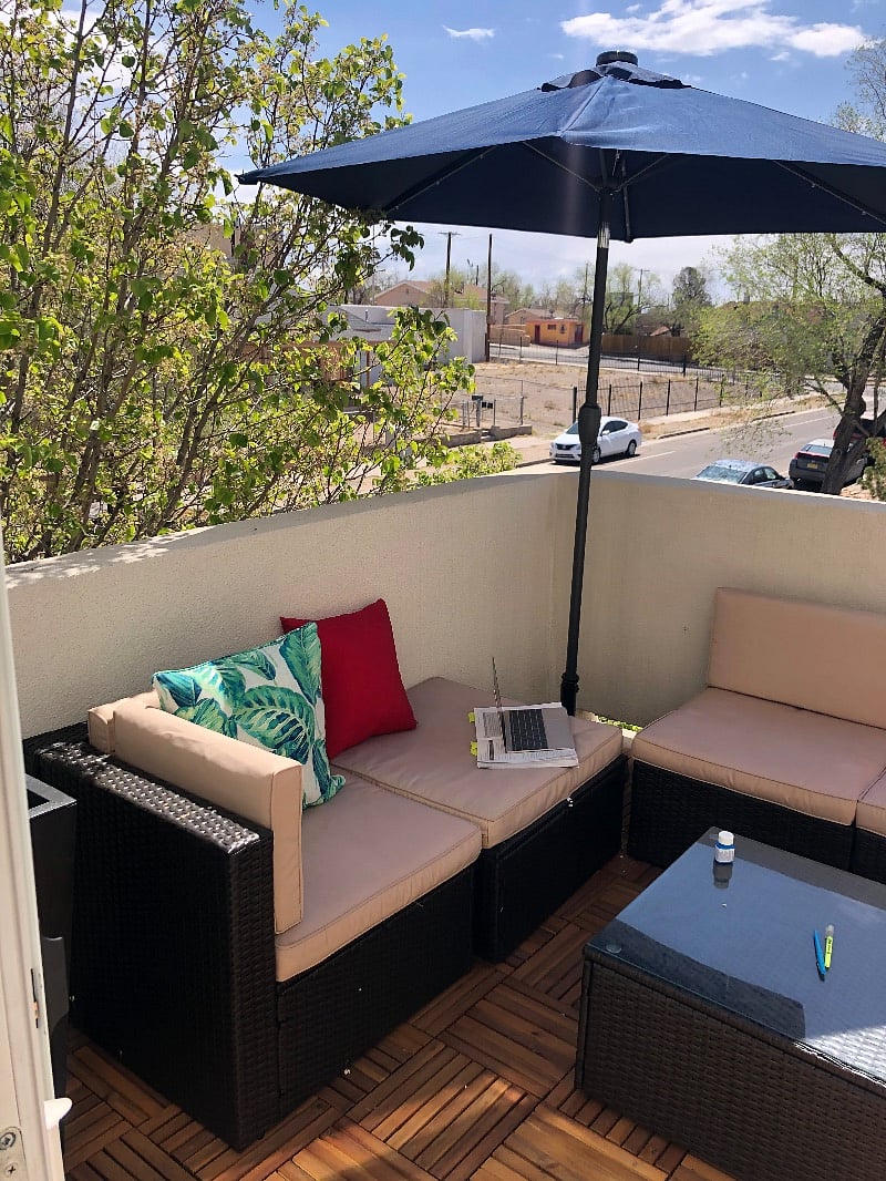 Outdoor patio area shaded by trees