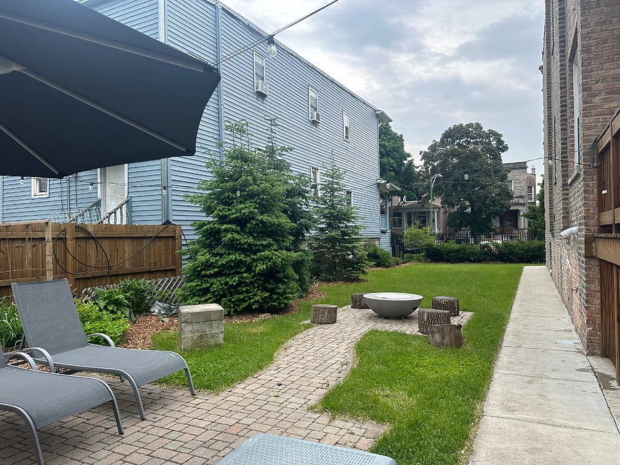 Lush, professionally landscaped garden. This photo shows the double lot feature of the house.