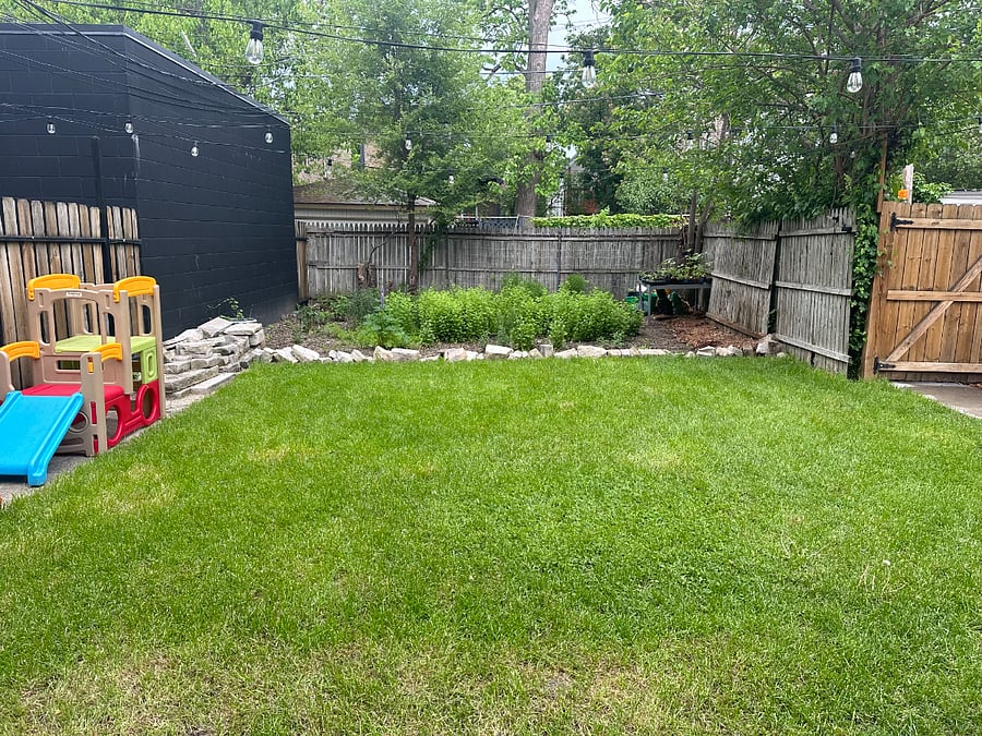 Lush, professionally landscaped garden. Native flower patch behind the home.