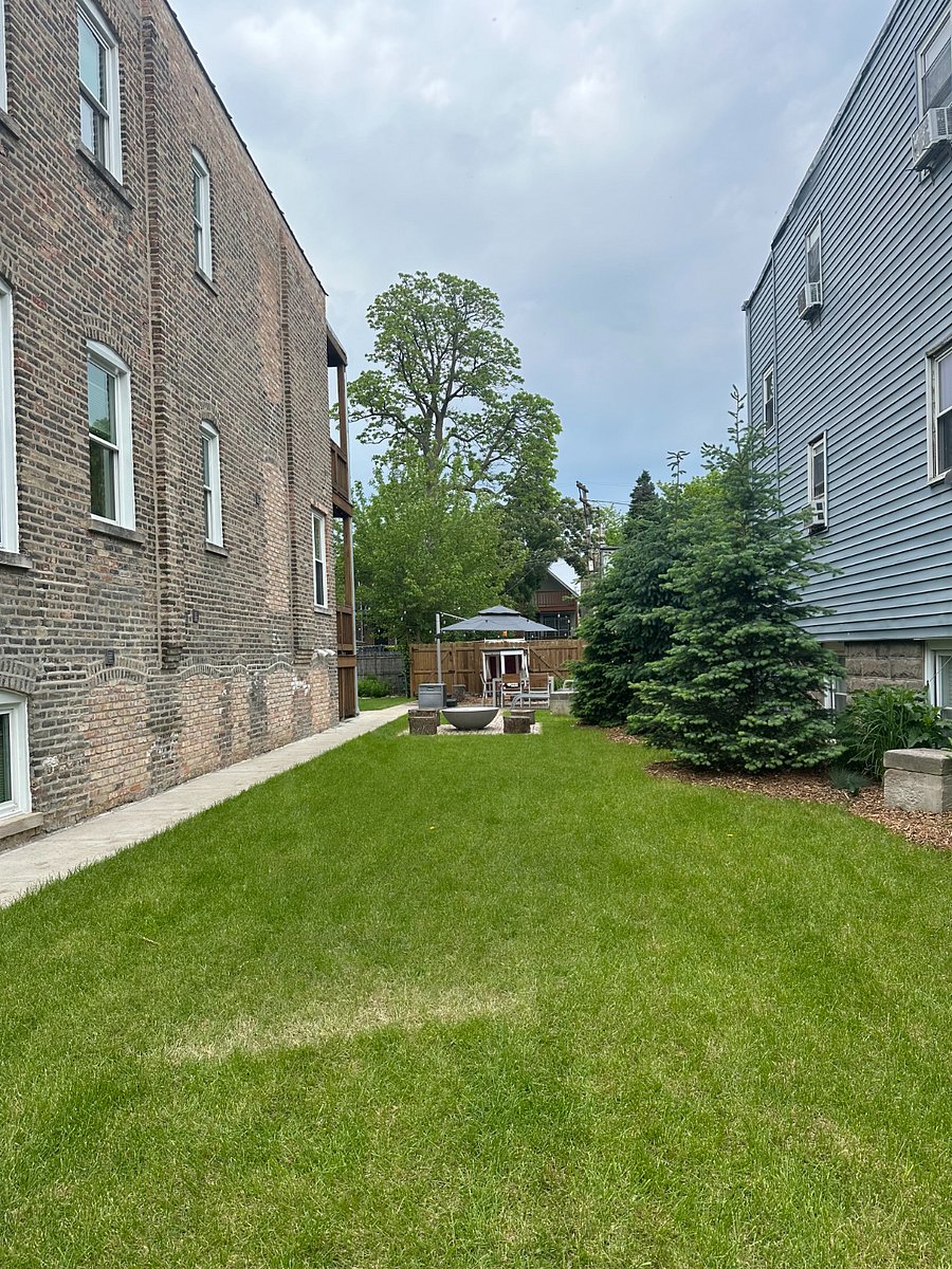 Lush, professionally landscaped garden. This photo shows the double lot feature of the house.