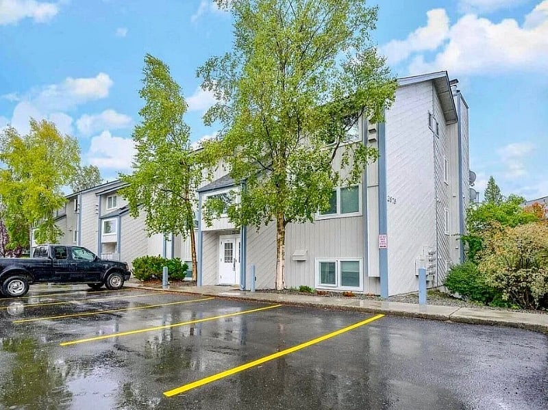Enter through the double doors, and go down four steps to the small hallway shared by just two units. You can also walk around the building to the right to unit facing the park-like setting.