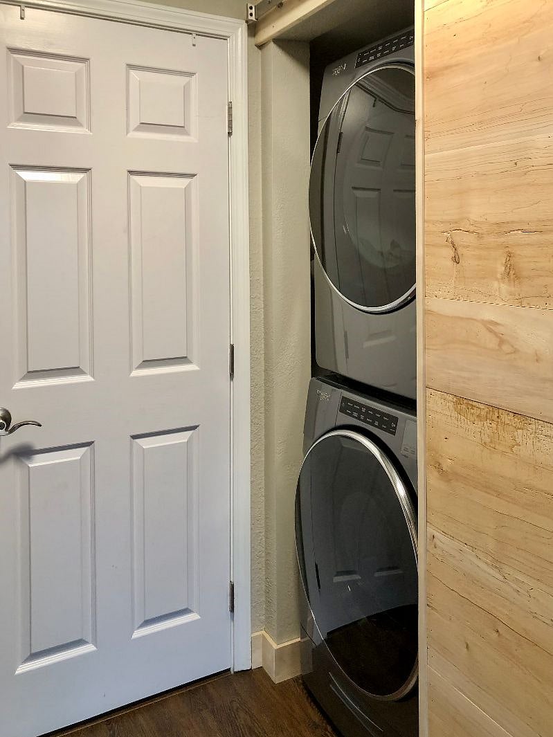 Whirlpool washer and dryer, with sliding Alaskan birch barn door to cover it when not in use.