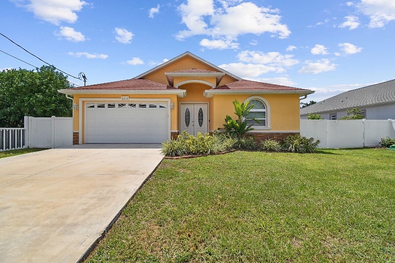 Front exterior view of the house. 2-4 cars can park in the driveway depending on the size. 
