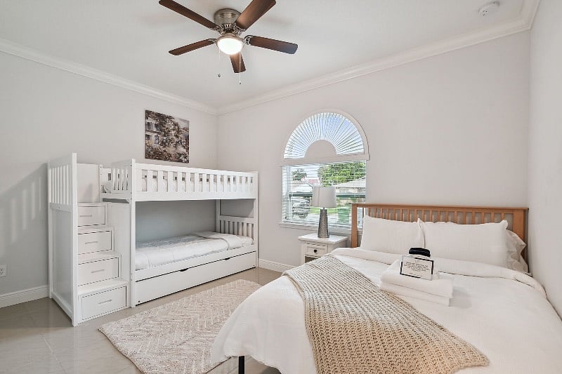 Guest Bedroom 1. Trundle bunk bed twin mattresses with pull out (3 total) and storage drawers on the steps. Additional queen size bed