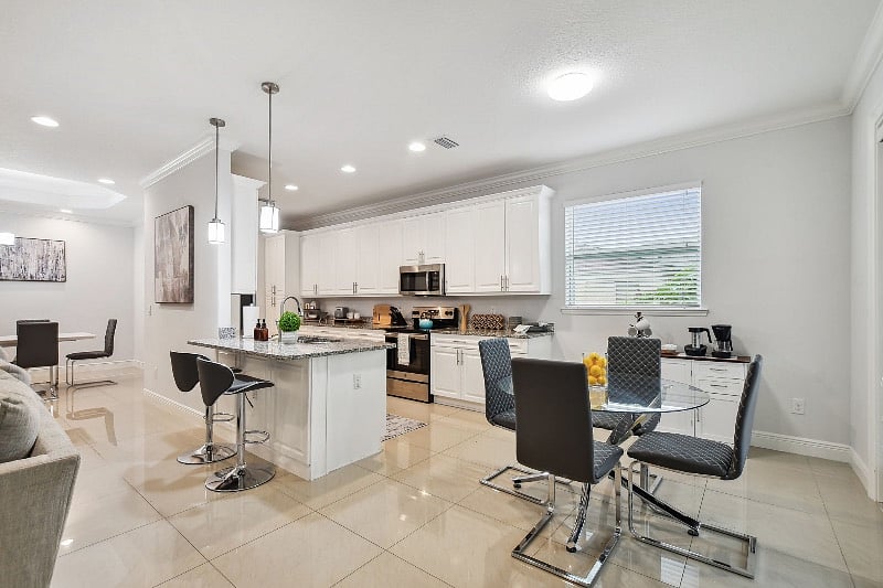 Additional dining table seating four in the kitchen area. Barstool seating available as well. 