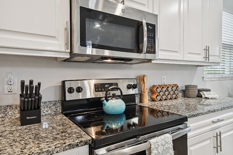 The modern stainless steel appliances and spacious countertops make it easy to prepare meals.