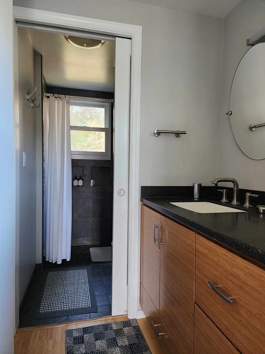 Tile shower and adjacent toilet and vanity upstairs