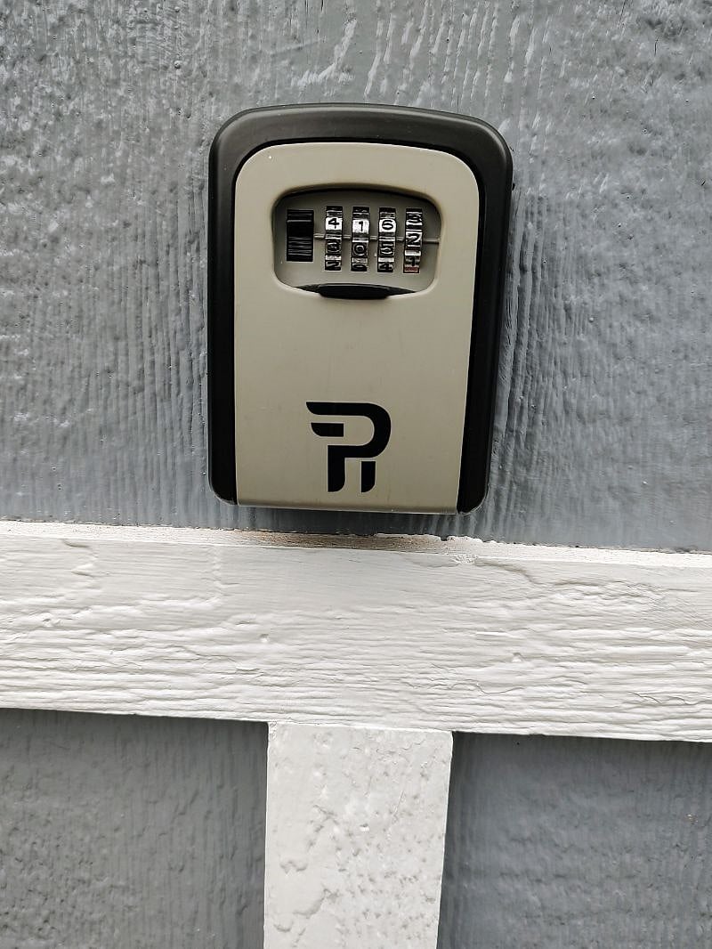 exterior lockbox attached to shed for access to house key and shed key.