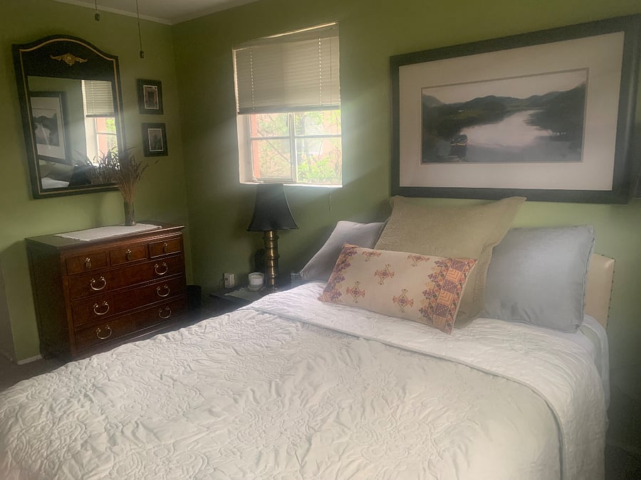 Full bed with north and east windows, ceiling fan and open closet