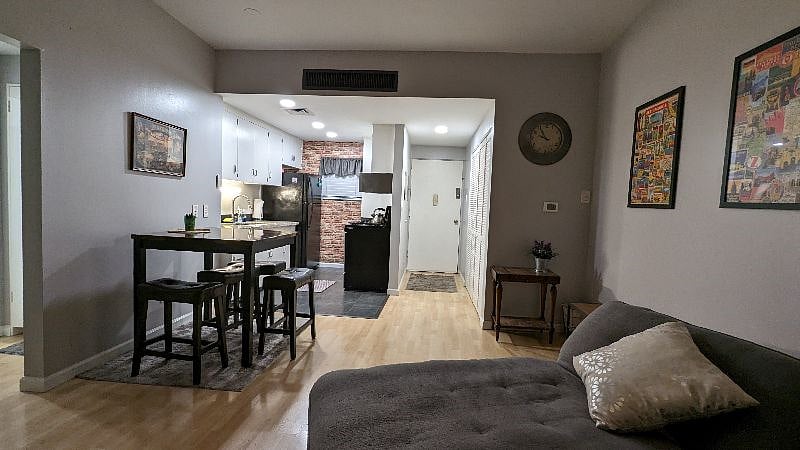 view of open living space into kitchen. tall dining table