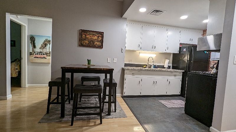 view of open living space into kitchen. tall dining table