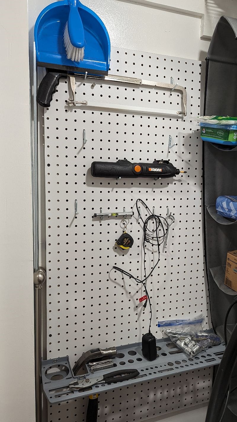 tools and cleaning supplies in front closet by entry door