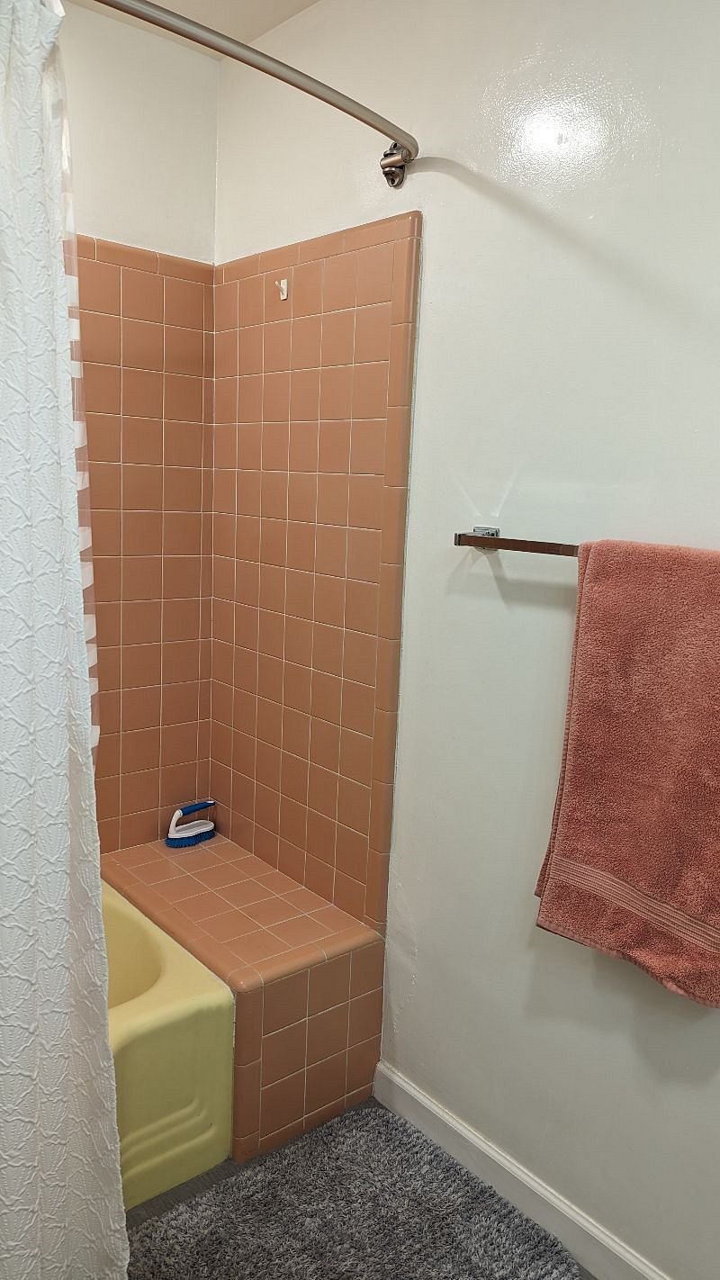 original tiled shower and fun yellow bathtub!